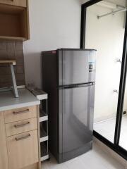 Modern kitchen with refrigerator and sliding glass door