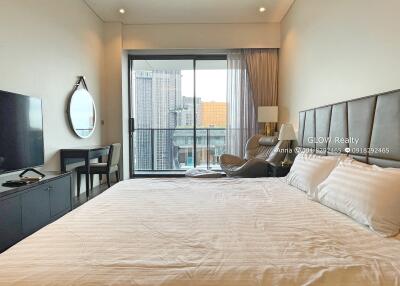 Spacious bedroom with modern furnishings and balcony view