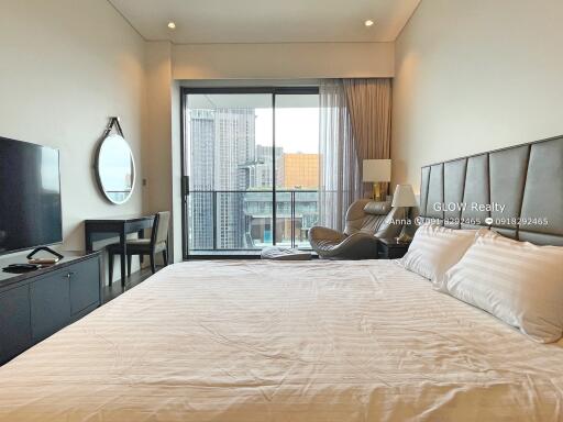 Spacious bedroom with modern furnishings and balcony view