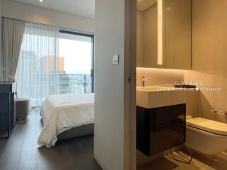 Bedroom with adjoining bathroom and city view