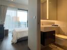 Bedroom with adjoining bathroom and city view