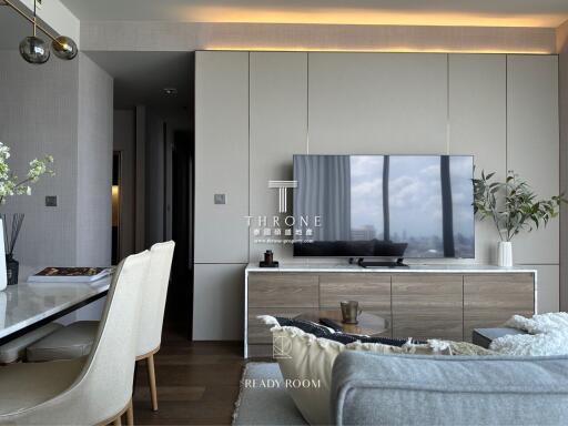 Modern living room with TV, dining table, and decorative plants