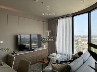 Modern living room with a large window offering a city view