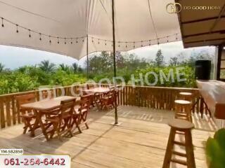 Spacious outdoor deck area with wooden flooring and tables