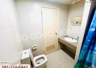 Bathroom with toilet, sink, mirror, and shower with curtain