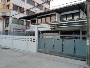 Front view of a residential building with gate