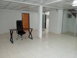 Spacious office area with a large desk and chair