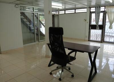 Spacious office with desk and large windows