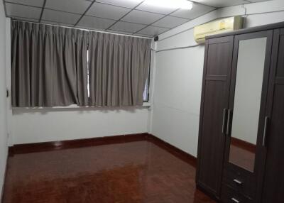 Bedroom with wardrobe and large window