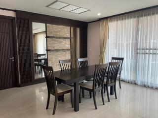 Modern dining room with dark wooden table and chairs