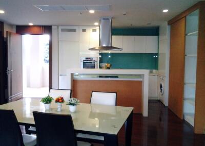 Modern kitchen and dining area with sleek appliances and contemporary decor