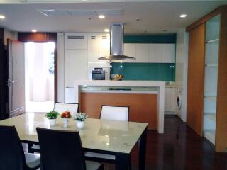 Modern kitchen and dining area with sleek appliances and contemporary decor