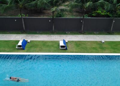 Outdoor swimming pool with sun loungers