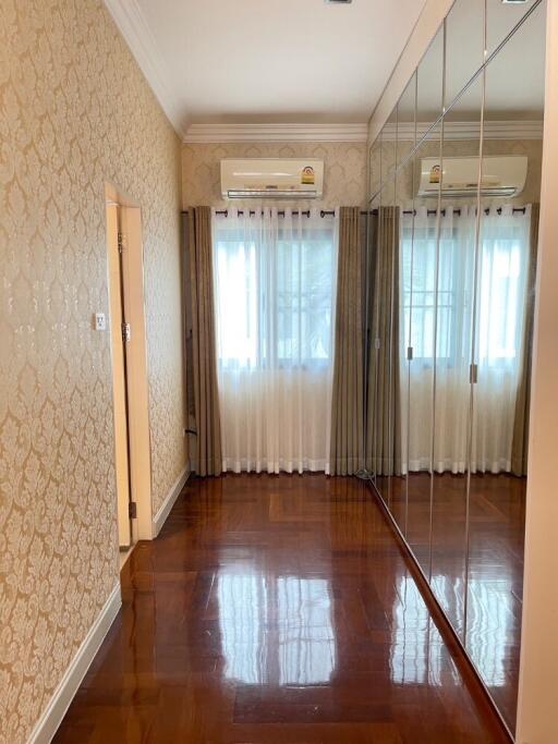 Bedroom with mirrored wardrobe and hardwood floor