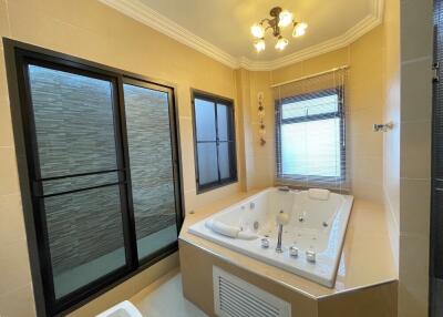 Spacious bathroom with a jacuzzi tub and large windows