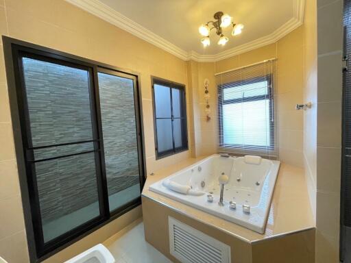 Spacious bathroom with a jacuzzi tub and large windows