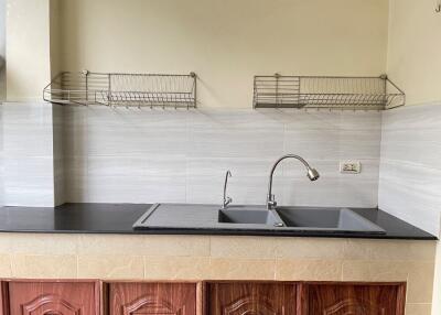 Kitchen with double sink and storage racks