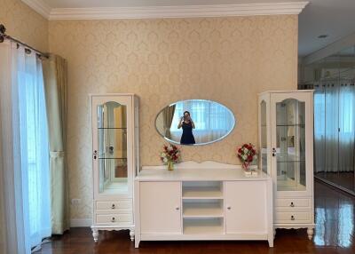 Bedroom with a vanity dresser and glass display cabinets