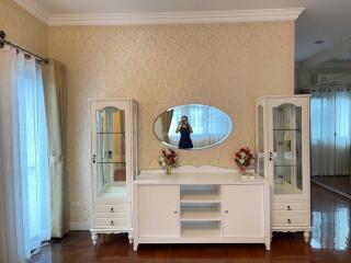 Bedroom with a vanity dresser and glass display cabinets