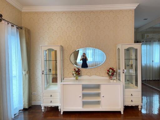 Bedroom with a vanity dresser and glass display cabinets