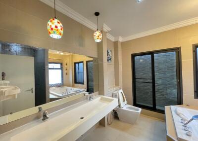 Modern bathroom with dual sink and large bathtub