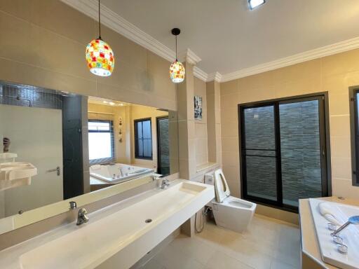 Modern bathroom with dual sink and large bathtub