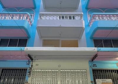 Exterior view of a multi-story residential building with balconies