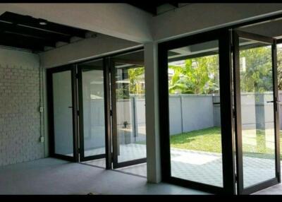 Spacious living area with large glass doors opening to the backyard