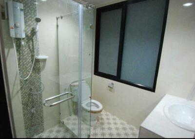 Modern bathroom with glass shower enclosure and vanity sink
