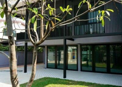 Modern building exterior with lawn and trees