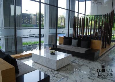 Modern lounge area with marble flooring and large windows