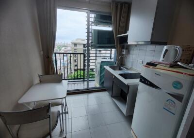 Compact kitchen with balcony view