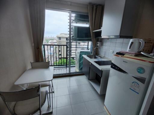 Compact kitchen with balcony view