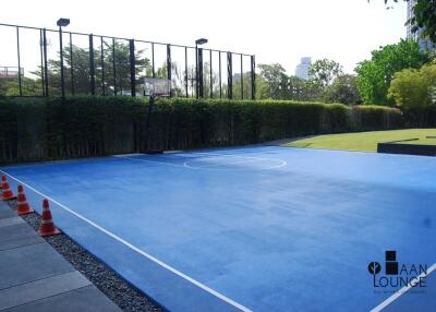 Outdoor basketball court with greenery