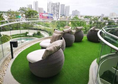 Spacious balcony with modern outdoor seating and city view