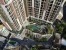 Aerial view of a modern residential building with a rooftop pool