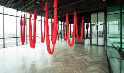 Modern interior with red aerial yoga hammocks