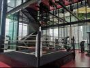 Modern gym with boxing ring and fitness equipment