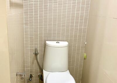 Modern toilet with shower and tiles