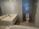 Modern bathroom with large mirror and ceramic fixtures