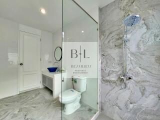 Modern bathroom with glass shower and marble tiles