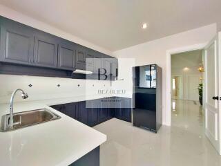 Modern kitchen with dark cabinets and stainless steel appliances