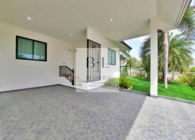 Covered outdoor area with stairs and lawn