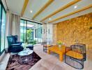 Spacious living room with large windows, wooden beams, and stone accent wall