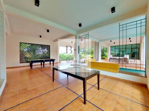 Spacious indoor recreational area with game tables and outdoor view