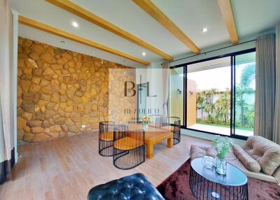 Living room with stone accent wall and large windows