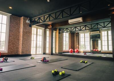 Well-equipped gym with fitness equipment and large mirrors