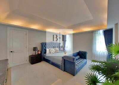 Spacious bedroom with modern lighting and luxurious bed