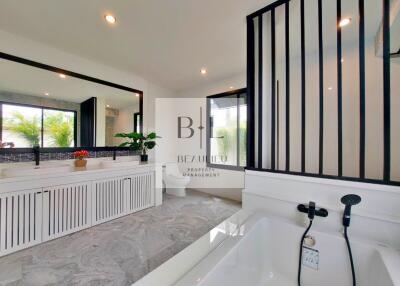 Modern bathroom with large mirror and bathtub