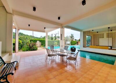 Outdoor patio with pool and seating area